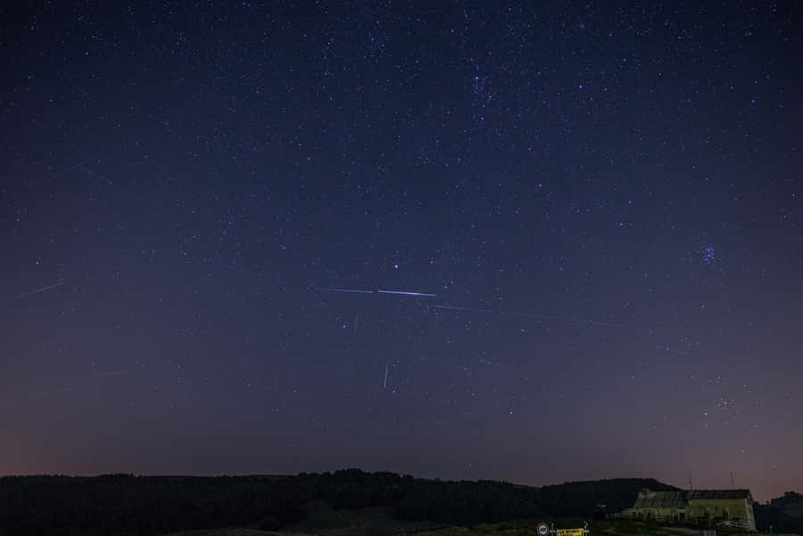 Spectacular Meteor Shower Across The Night Sky Wallpaper