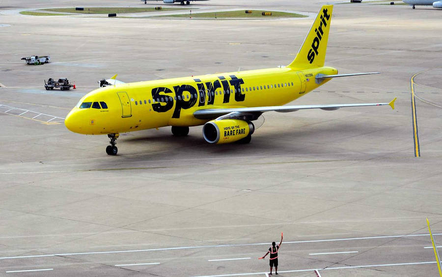 Spirit Airlines Airplane With Airport Police Wallpaper