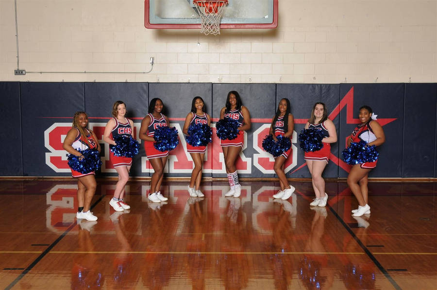 Spirited Cheerleaders Motivating On Court Wallpaper