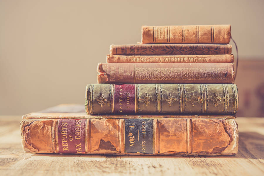 Stack Of Old Reference Books Wallpaper