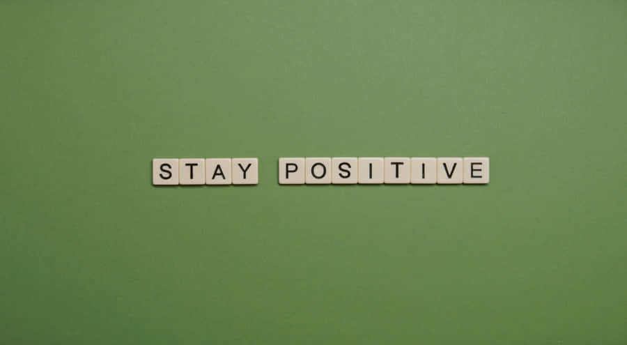 Stay Positive Scrabble Word On Green Background Wallpaper