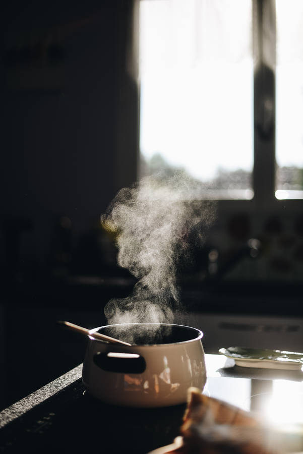 Steam Rises From A Simmering Pot Of Flavorful Concoction. Wallpaper