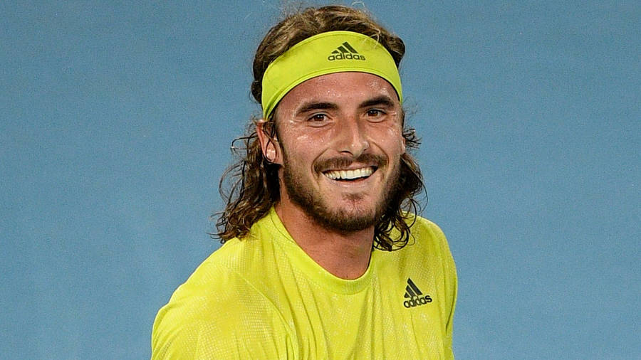 Stefanos Tsitsipas In Yellow Adidas Shirt Wallpaper