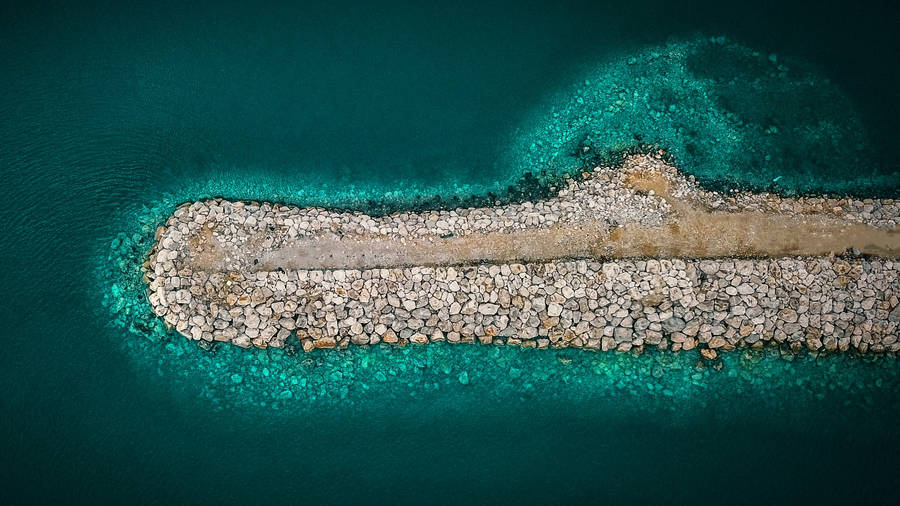 Stone Walkway In Ocean Blue Waters Wallpaper