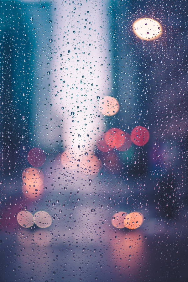 Street Lights Gleaming Through Sparkling Raindrops Wallpaper