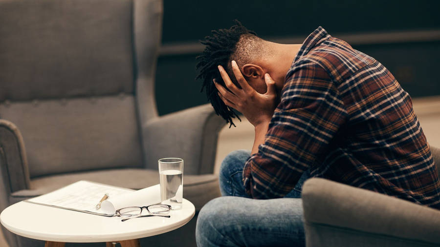 Stressed African Man Deep In Thought Wallpaper