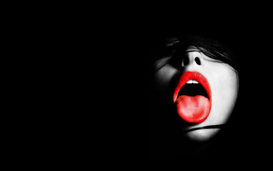 Striking Red Lips On A Dark Background Wallpaper