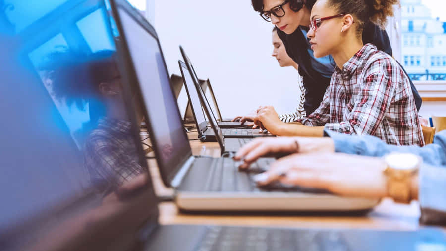 Students Working On Computers Wallpaper