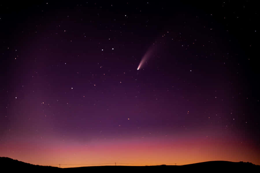 Stunning Comet Travelling Through The Star-studded Night Sky Wallpaper