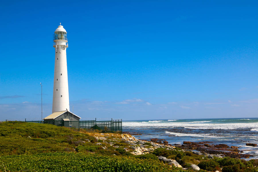 Stunning View Of The Slangkop Lighthouse Illuminating The Twilight Sky, Cape Town Wallpaper