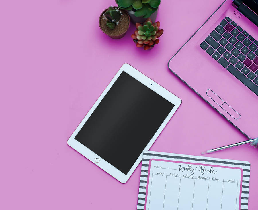 Stylish And Cute Laptop On A Classic Wooden Tabletop Wallpaper