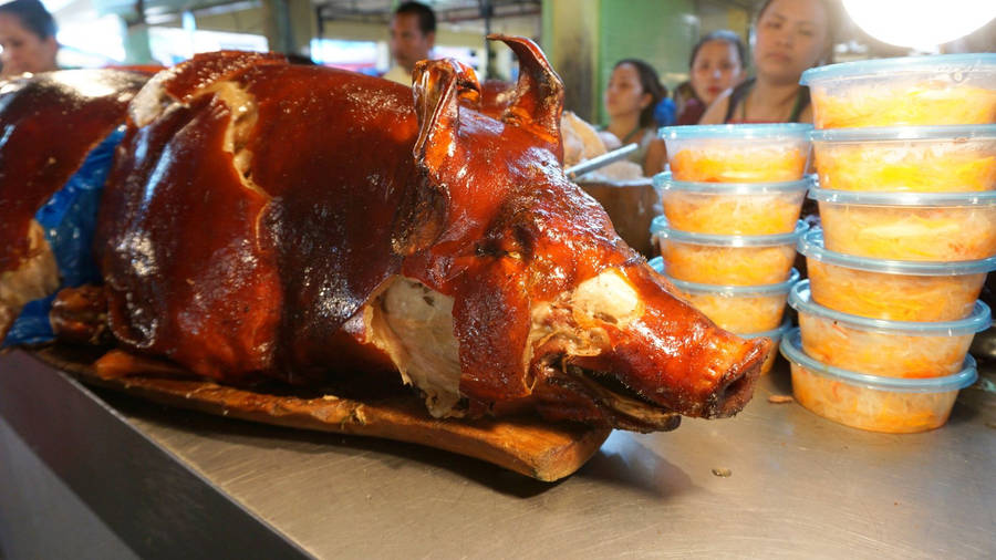 Succulent And Crunchy Lechon At A Local Market Wallpaper