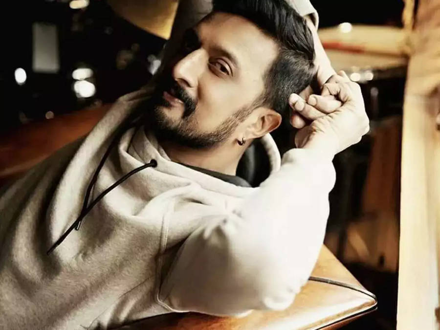 Sudeep Leaning On Chair Wallpaper