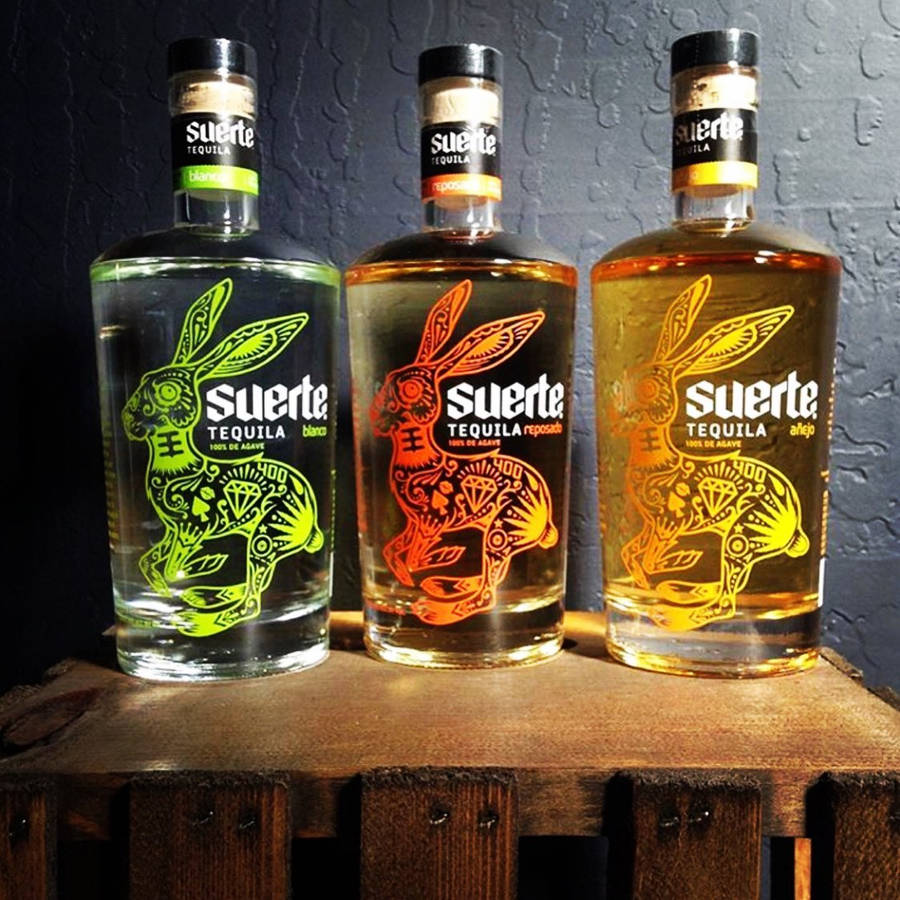 Suerte Stylish Tequila Bottles Wallpaper