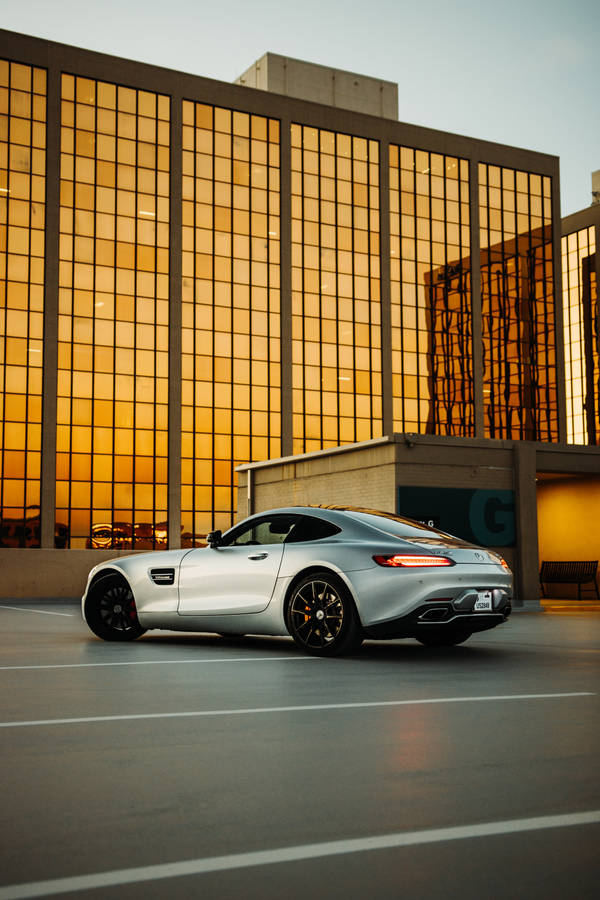 Surreal Snapshot Of A Majestic Amg Gtr Amongst Golden Buildings Wallpaper