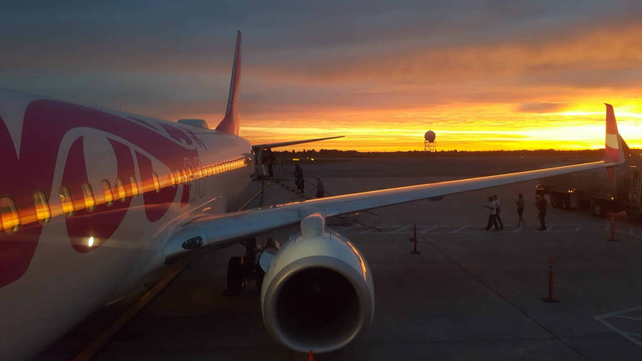 Swoop Airlines Jet Engine Illuminating The Skies Wallpaper