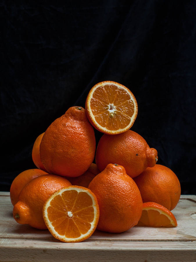 Tangelo Fruits On A Chopping Board Wallpaper