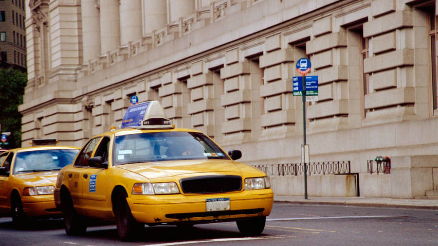 Taxi At The Side Of Classical Building Wallpaper