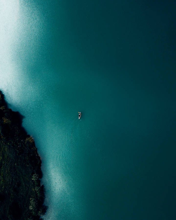 Teal Ocean And Boat Wallpaper