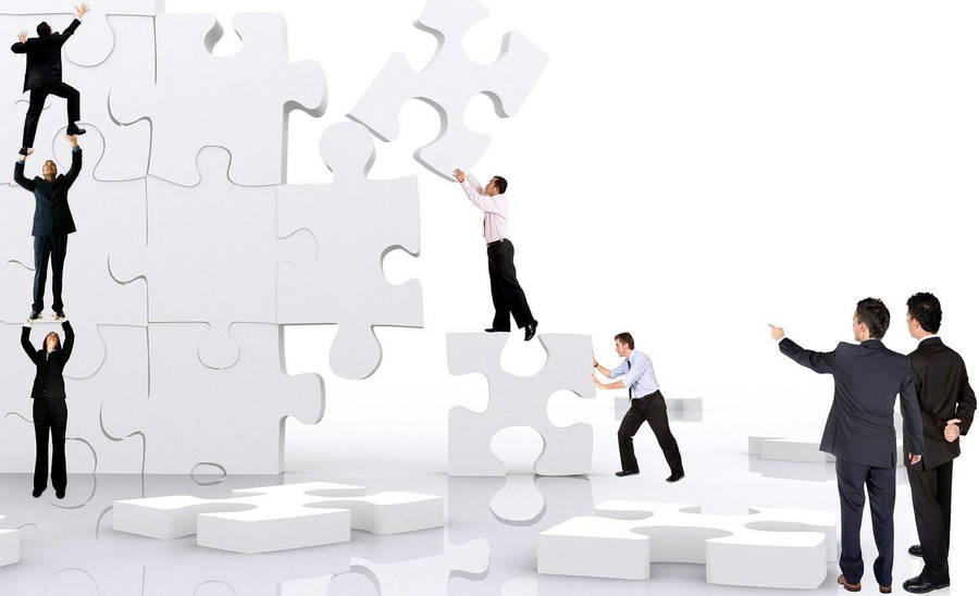 Teamwork Men Solving Jigsaw Puzzle Wallpaper