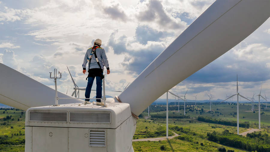 Technician Servicing Wind Turbine Wallpaper