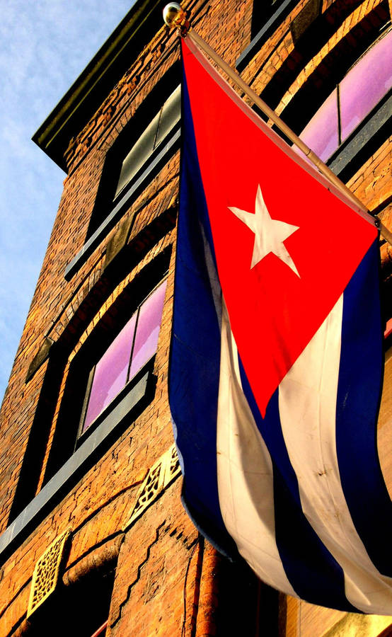 The Cuban Flag Proudly Displayed Outside A Building. Wallpaper