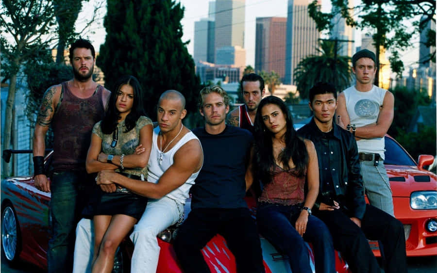 The Gang Of Street Racers From Fast And Furious 1 Hit The Road Wallpaper