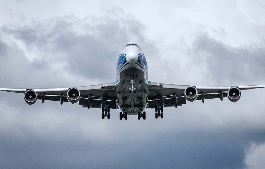 The Grandeur Of A Flying Jumbo Jet Wallpaper