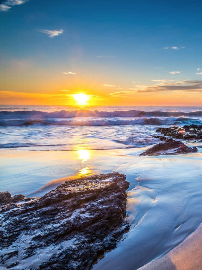 The Perfect Combination. Relaxing Beach Vibes And A Handy Phone To Keep Connected. Wallpaper