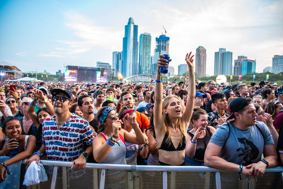 Thousands Of Fans Having A Great Time Enjoying The Music At Lollapalooza In Chicago Wallpaper