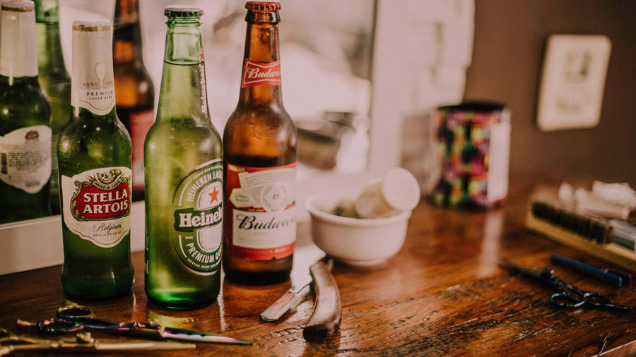 Three Different Alcohol Bottles Against A Mirror Wallpaper