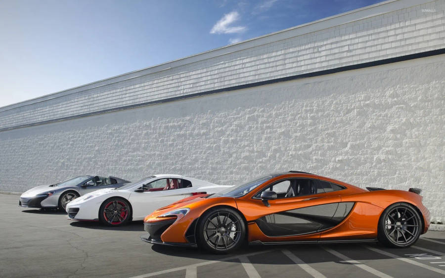 Three Mclaren Spyder Vehicles Parked Wallpaper