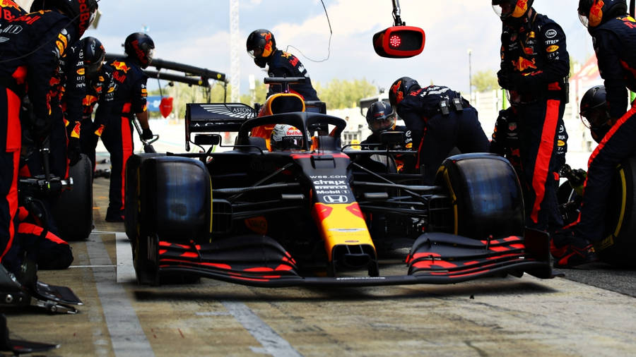 Thrilling Action At The Red Bull Racing Pit Stop Wallpaper