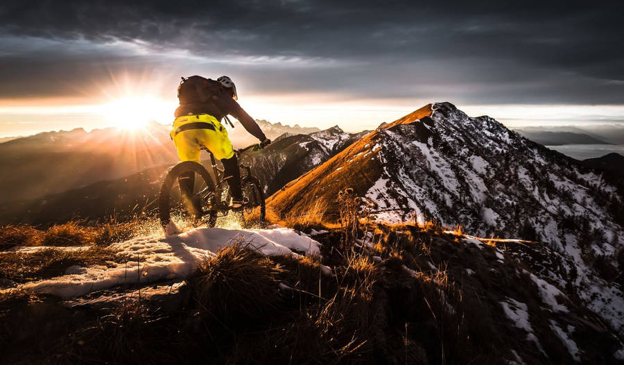 Thrilling Mtb Ride On A Snow-covered Mountain Wallpaper