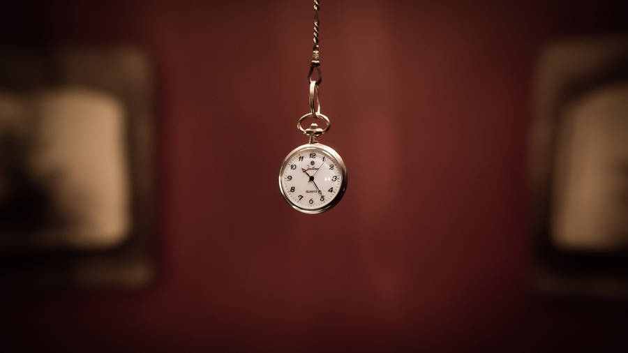 Tiempo Pocket Watch In Blurry Brown Backdrop Wallpaper