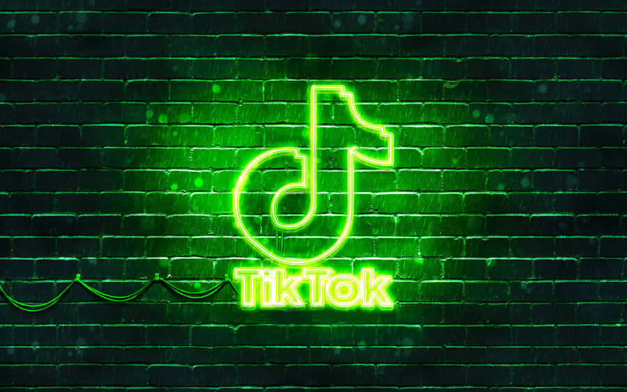 Tiktok Neon Sign On A Brick Wall Wallpaper