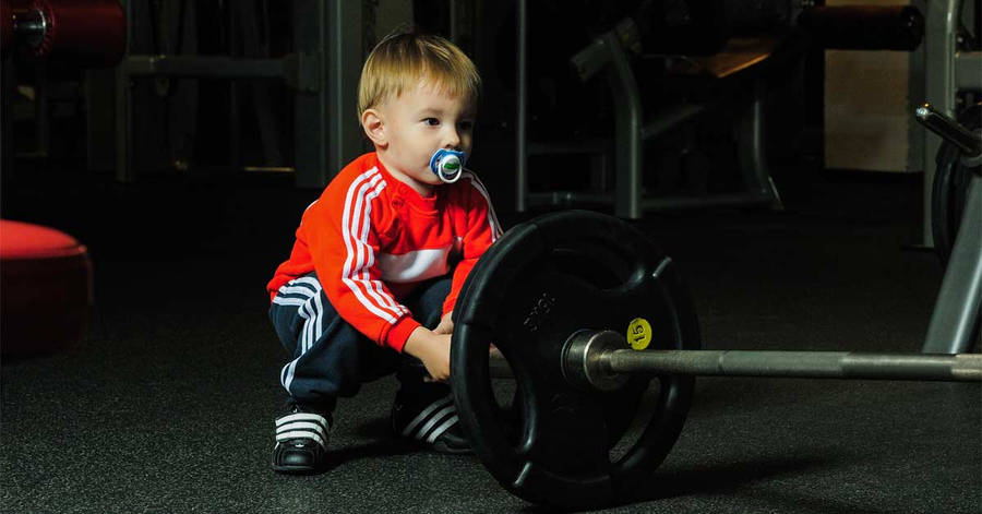 Toddler At Weight Lifting Gym Wallpaper