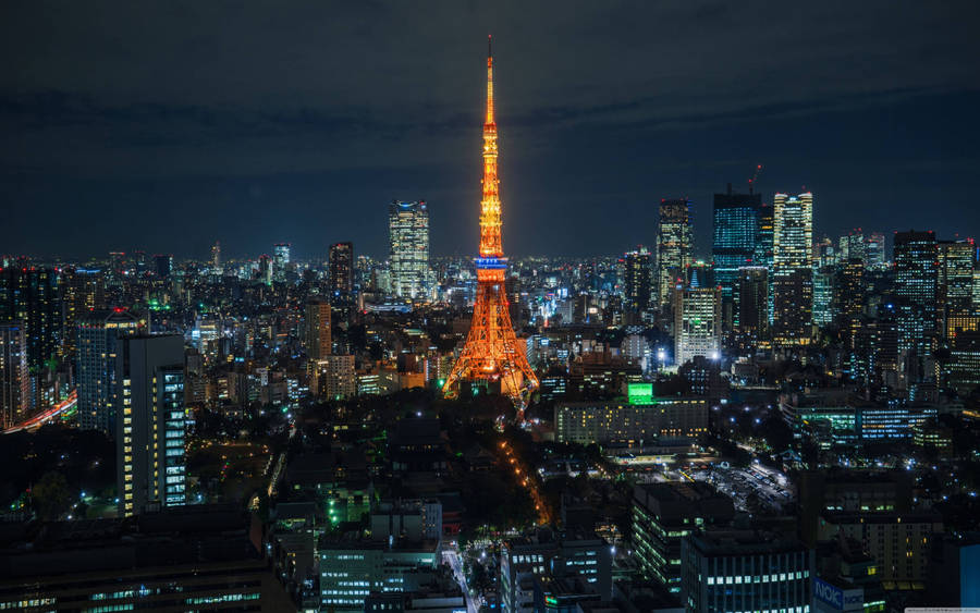 'tokyo Tower Standing Tall Amidst The Dazzling Tokyo Skyline' Wallpaper