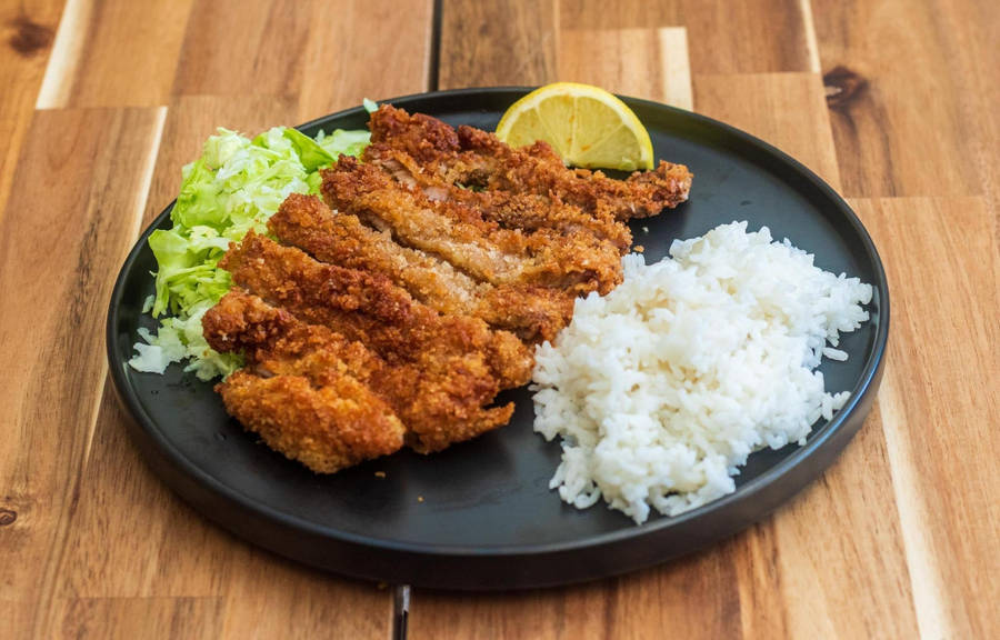 Tonkatsu Served On A Round Plate With Rice Wallpaper