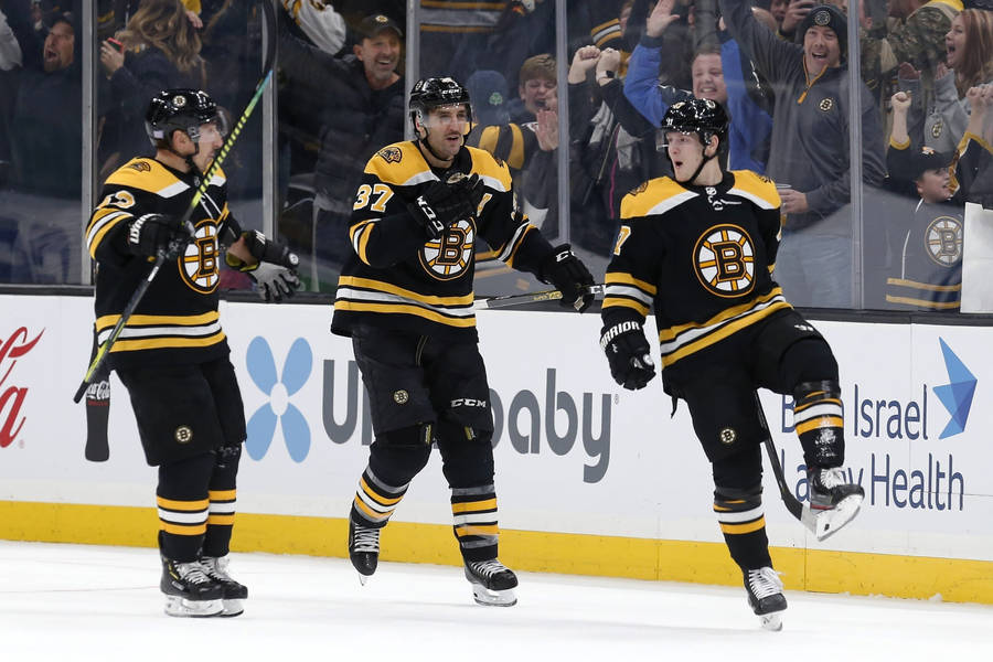 Torey Krug With Brad Marchand And Patrice Bergeron Wallpaper