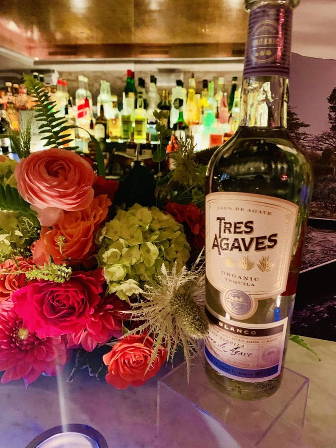 Tres Agaves Organic Blanco Tequila Amidst Flowers Wallpaper