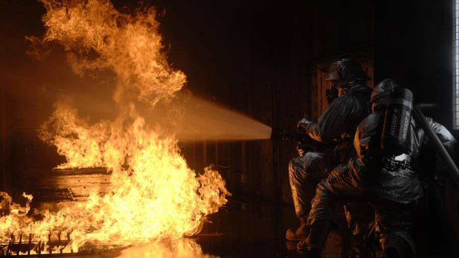 Two Firefighters Putting Out Fire Wallpaper