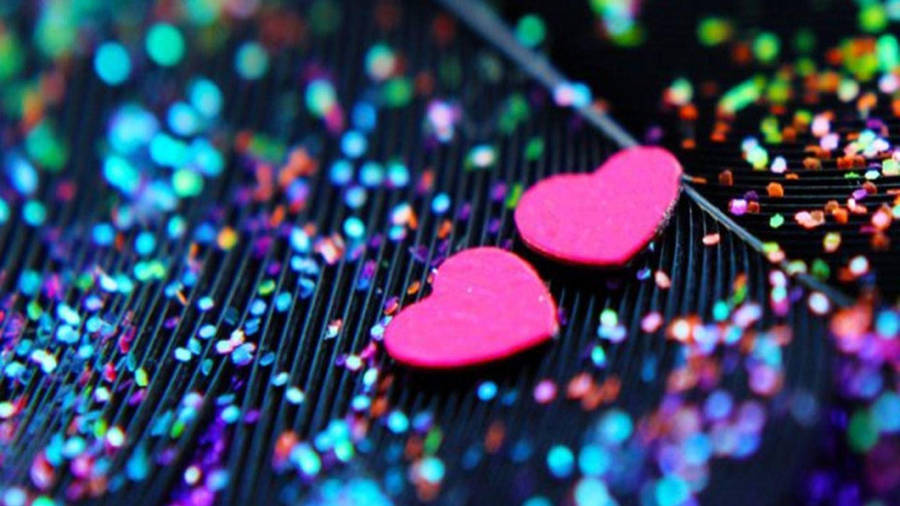 Two Pink Hearts On Sparkly Background Wallpaper