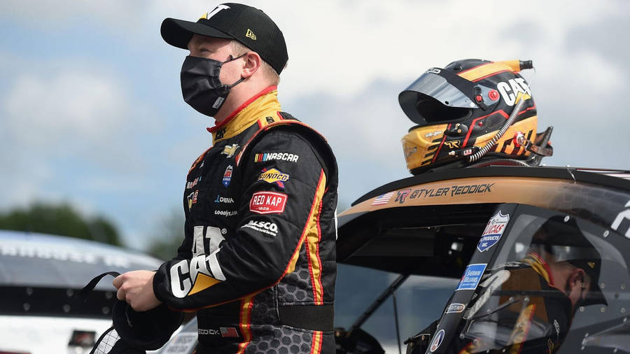 Tyler Reddick With Helmet Preparing To Speed In His Racing Car Wallpaper