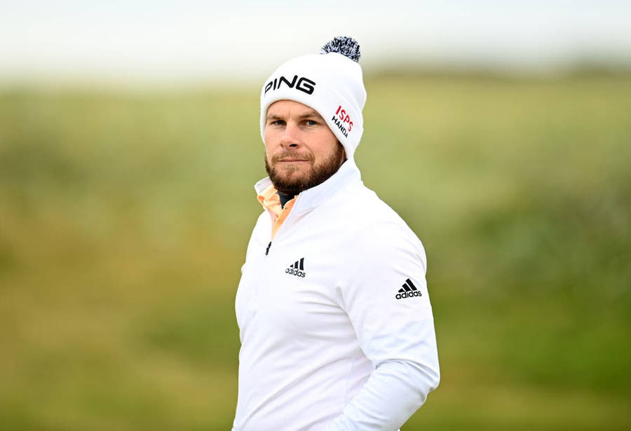 Tyrrell Hatton Showcasing His Swing Technique During A Golf Tournament Wallpaper