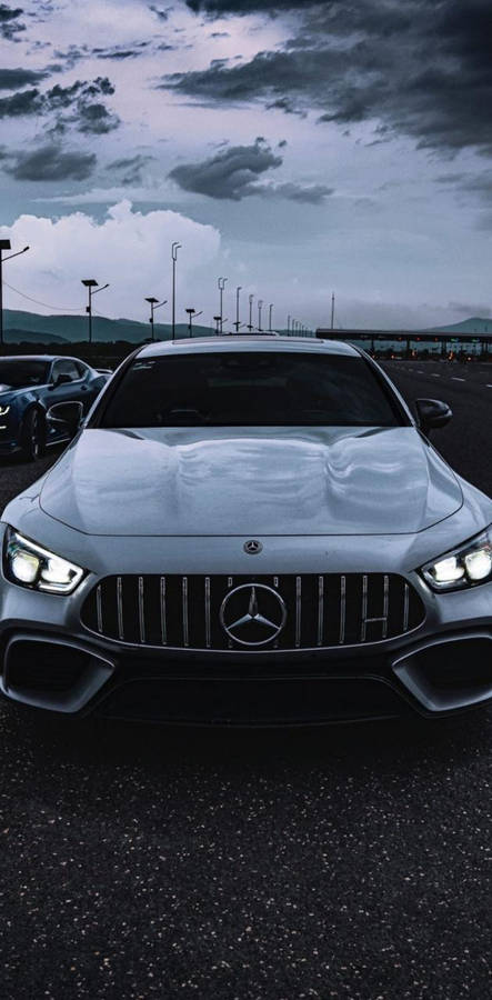 Unleashing Power - White Amg Under Mysterious Dark Sky Wallpaper