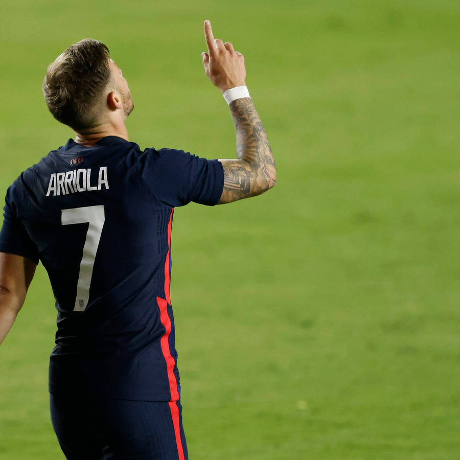 Usmnt Paul Arriola Pointing Towards Sky Grateful Wallpaper