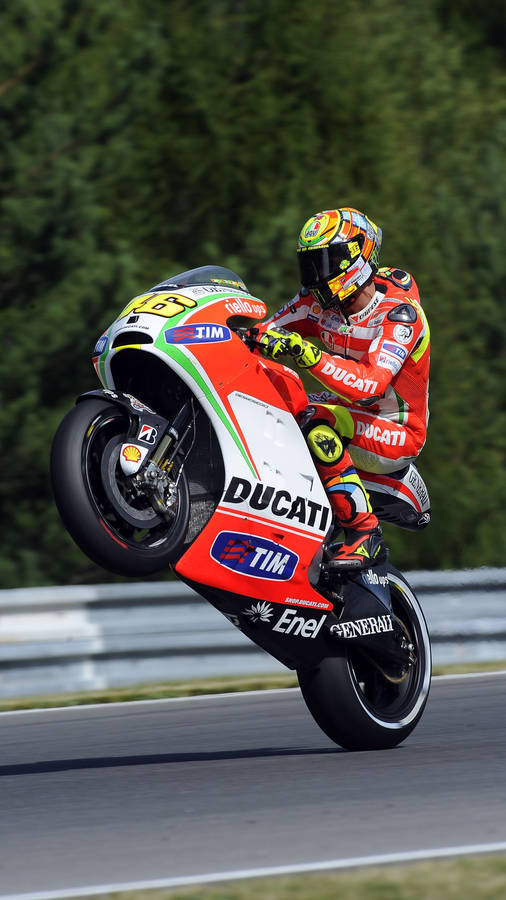 Valentino Rossi Racing On A Red Ducati Gp11 Wallpaper