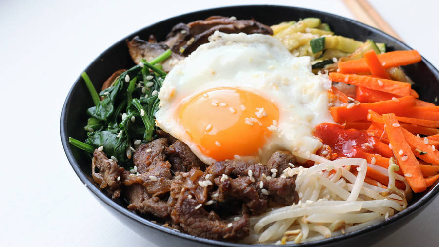 Vibrant And Traditional Korean Bibimbap Dish Wallpaper