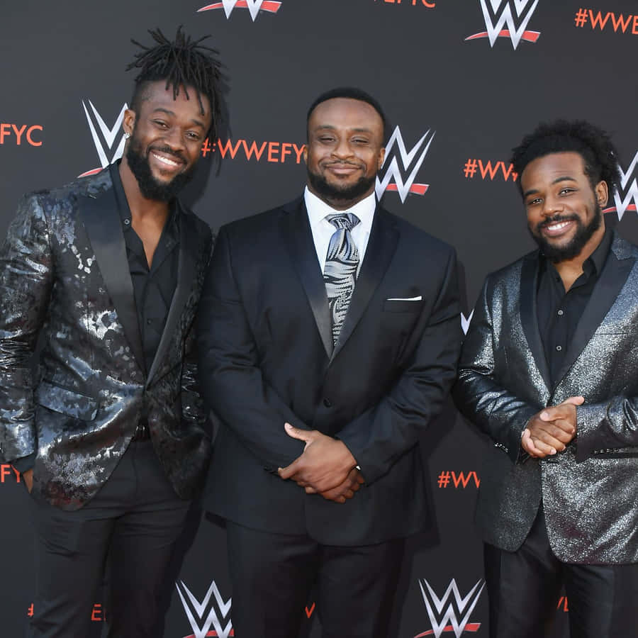 Vibrant Image Of Wwe Superstar Kofi Kingston, Posing With The Big E And Xavier Woods. Wallpaper